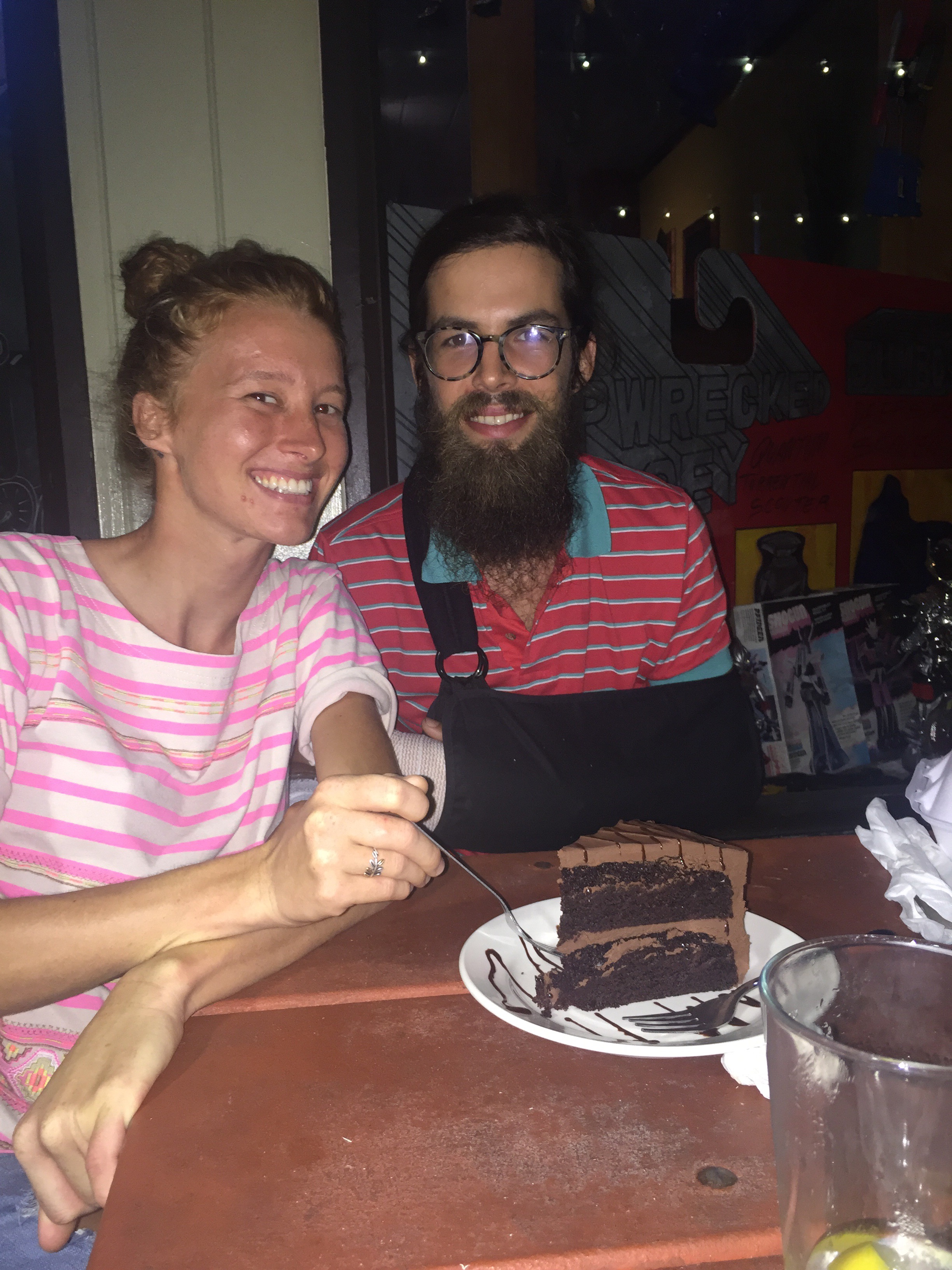 Tay and Adam splitting a vegan cake slice for her birthday