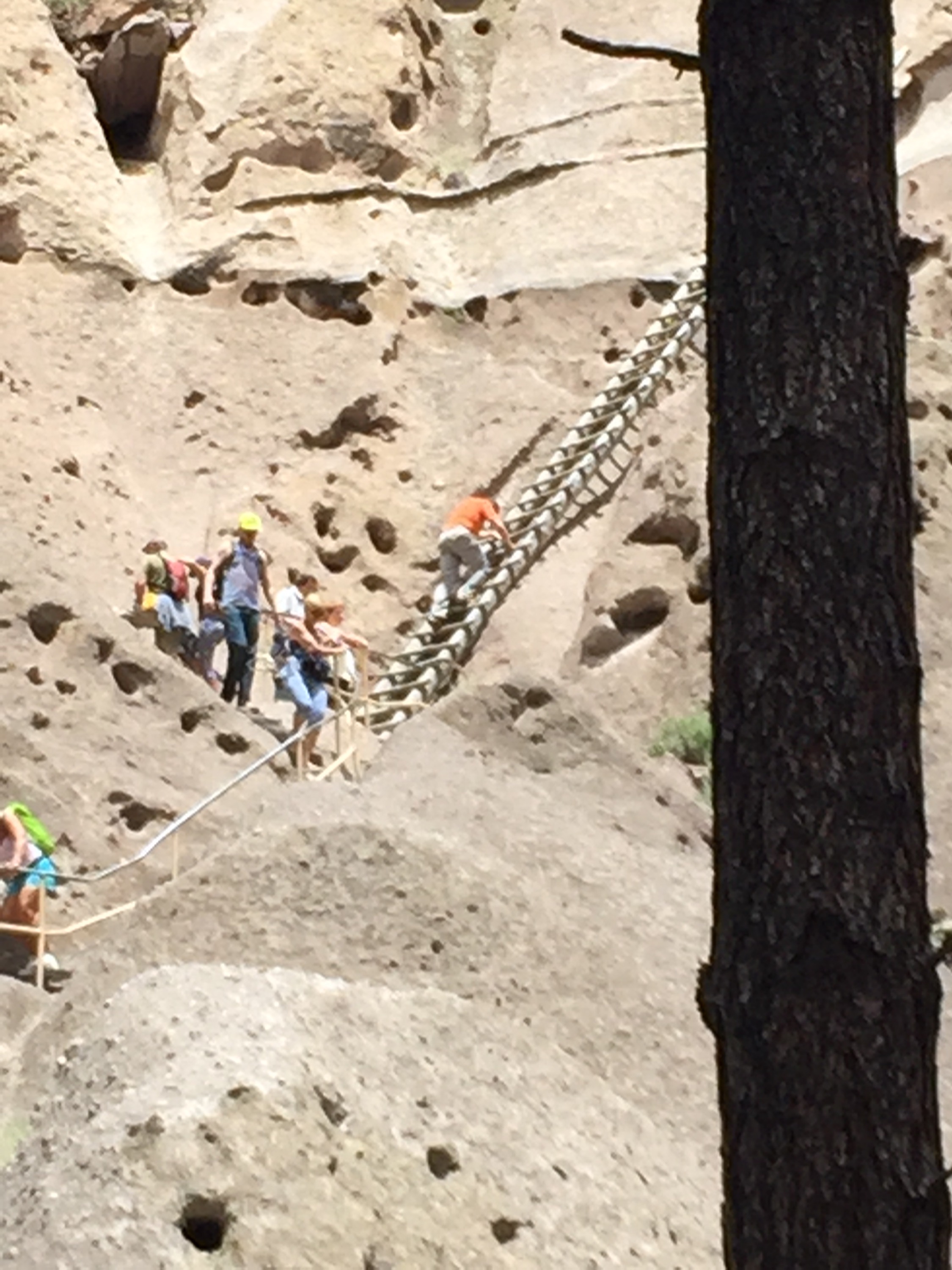 Ian climbing up to see a Pueblo home